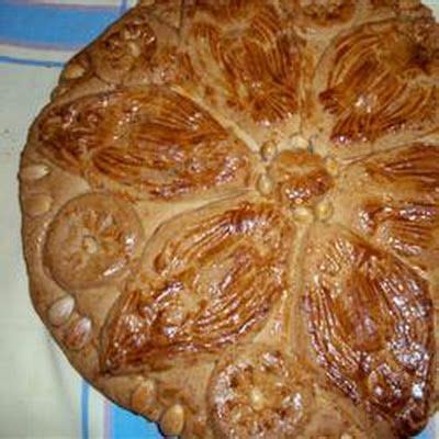 side view of Vaselopita - Greek New Years Cake dusted with powdered sugar with a slice cut out of it