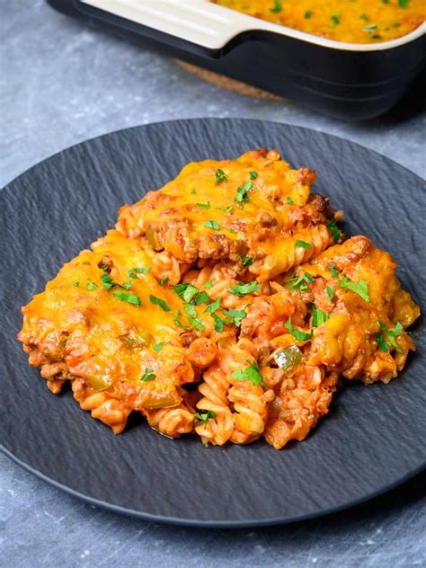 top-down view of a white 9x13 casserole dish of Grandmaâ��s ground beef casserole with a scoop out a