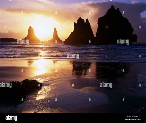 Sunset silhouettes the many offshore sea stacks in Oregon's Boardman State Park on the southern ...