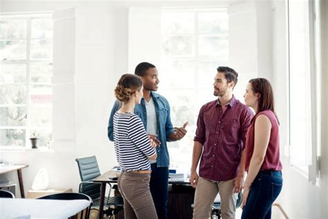 Group of People Standing in a Room Talking 的图像结果