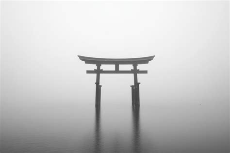 Minimalist black and white photograph of a torii gate reflecting on ...