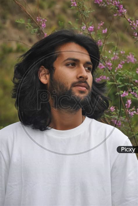 Image of Closeup of a good looking bearded and long haired Indian young ...
