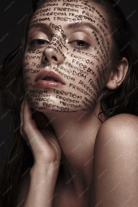 Premium Photo | Portrait of beautiful girl with painted words on her ...