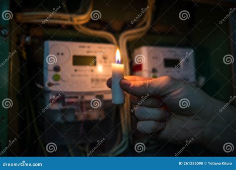 Candle Shining Light in the Dark Near Electricity Meter during Power Outage at Home. No ...