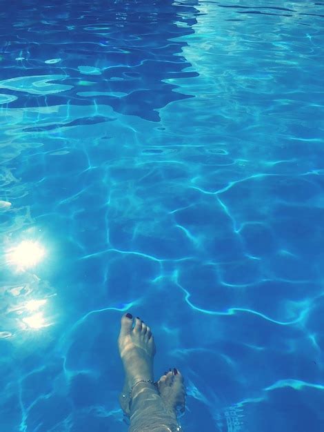 Low section of woman in swimming pool | Premium AI-generated image