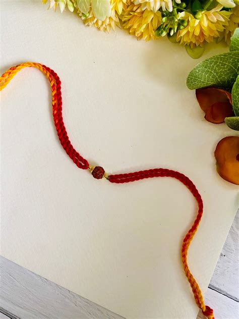 Single Rudraksha Red Yellow Bhia Rakhi – Madhurya Rakhi