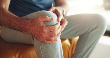 Knee pain tension and hands of man in home for fibromyalgia emergency ...