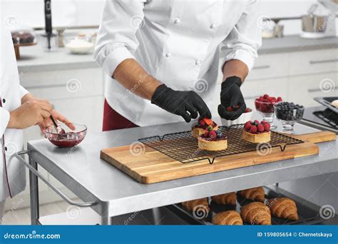 Pastry Chefs Preparing Desserts at Table in Kitchen Stock Photo - Image of kitchen, croissant ...