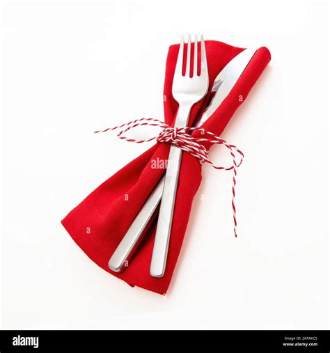 Holiday table setting, celebration dinner. Cutlery, red cloth napkin ...
