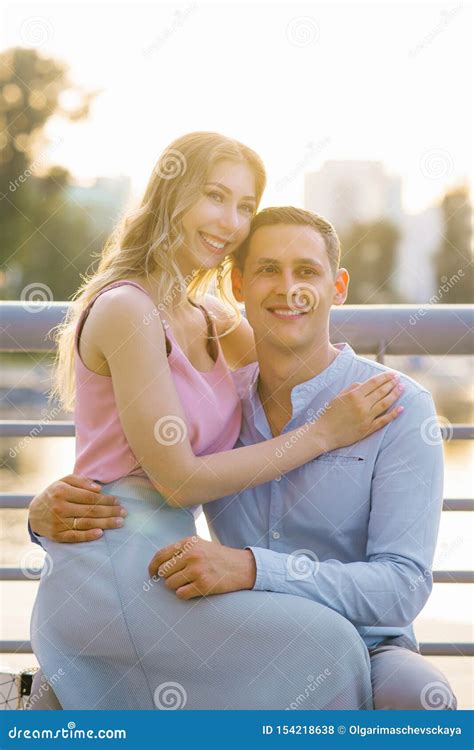 Beautiful Girl Sitting in a Guy`s Lap, Hugging Him Stock Photo - Image ...