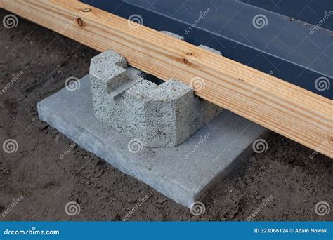 Close-up of a Concrete Foundation Block and Wooden Beam for Building a ...