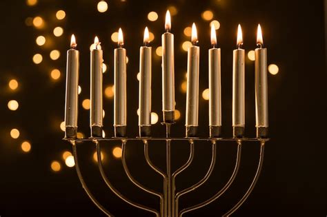 Menorah with candles near abstract garland lights | Free Photo