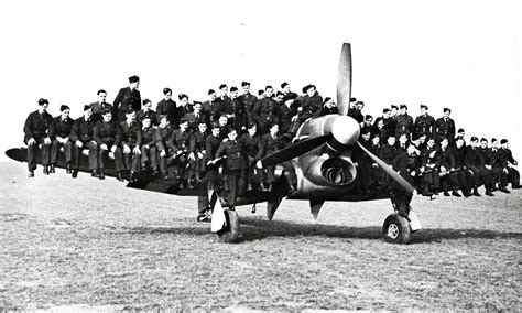 Royal Air Force ground crew preparing an RAF Typhoon fighter jet. It is night-time and the team are