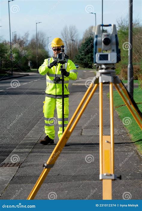 Land Surveyor Performing Initial Survey of the Road Levels and Kerb ...