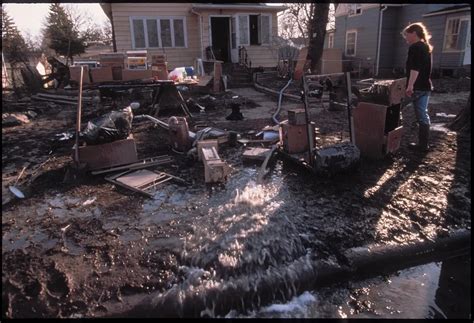 Residents of Grand Forks muck out their homes and use pumps to remove ...