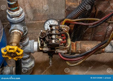 Well Water Pump Pressure Switch and Plumbing Pipes. Stock Photo - Image ...