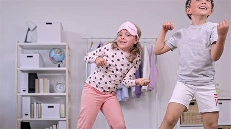 two children playing with a wii in a room 32352953 Stock Video at Vecteezy