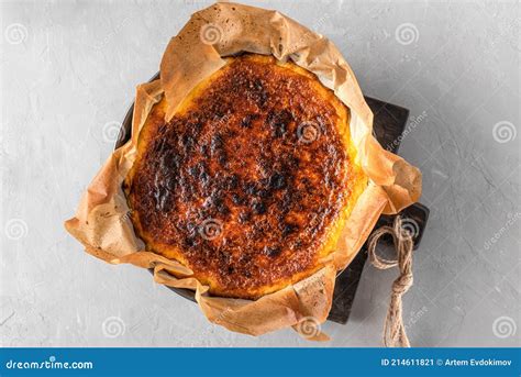 Whole Basque Burnt Cheesecake in Baking Dish on Concrete Table. Top ...