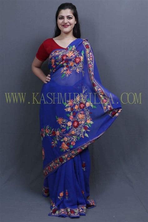 Royal blue colour saree with aari work border and bold paisleys make