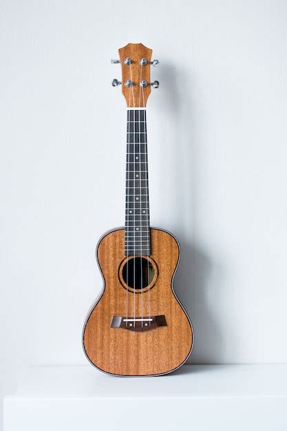 Ukulele on a white | Premium Photo