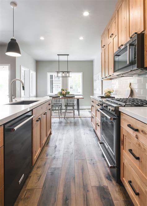 a kitchen with wooden cabinets and black stove top oven next to a ...
