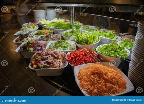 An Evening Buffet with Ready-made Salads and Vegetables To Mix Yourself ...