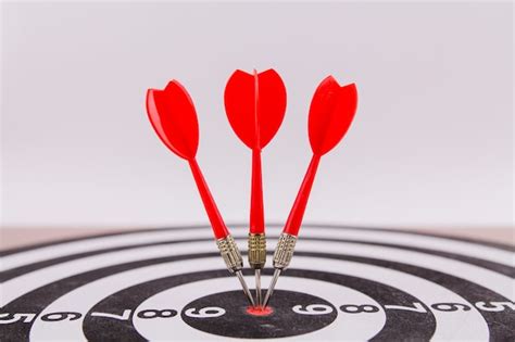 A red dart darts in the center of the target hit the target won ...