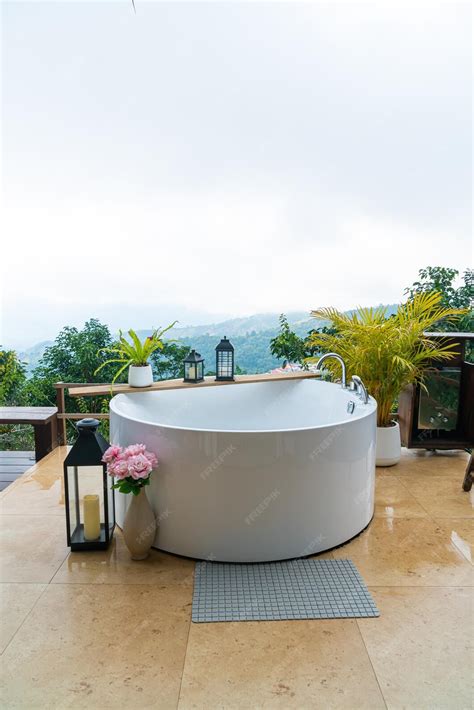 Premium Photo | Outdoor bath tub with beautiful mountain view background