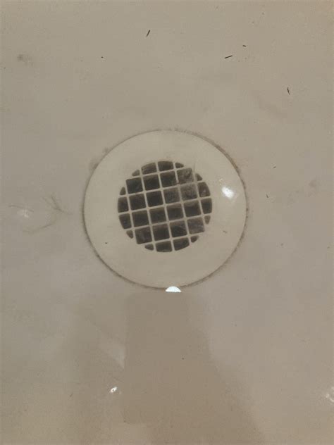 Slow draining shower. Does this little grate pop off with a screw ...