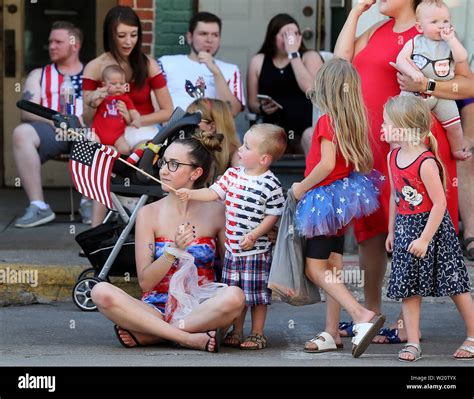 Bettendorf, Iowa, USA. 4th July, 2019. Ashley Bearden, left holds on to ...