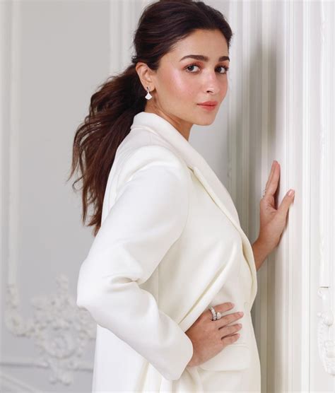 Alia Bhatt wore a strong white caped pantsuit in Doha | Vogue India ...