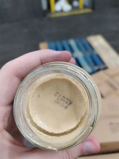 This bottle of Grey Poupon had no lid, but had the expiration date ...