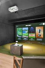 A High-End Indoor Golf Simulator Setup Showing The Screen, Hitting Mat, And Projector, Illustrating How Golf Simulators Work.