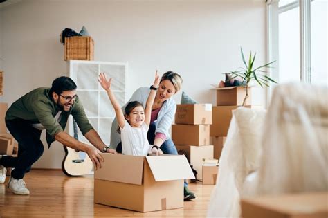 Carefree family having fun while moving into new home | Free Photo