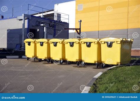 Yellow Trash Cans on Wheels for Waste Collection Stock Image - Image of ...