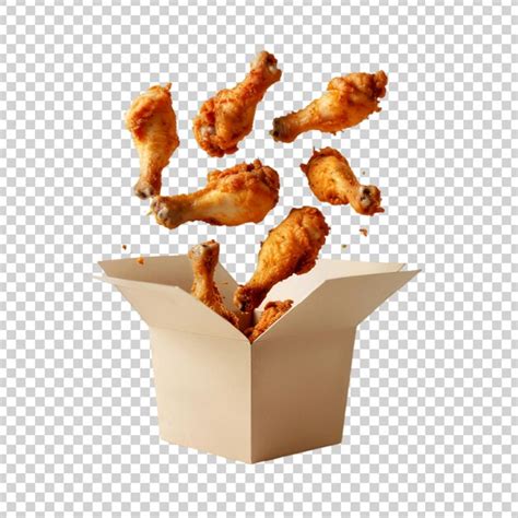 Floated fried chicken legs falling into paper box isolate on ...