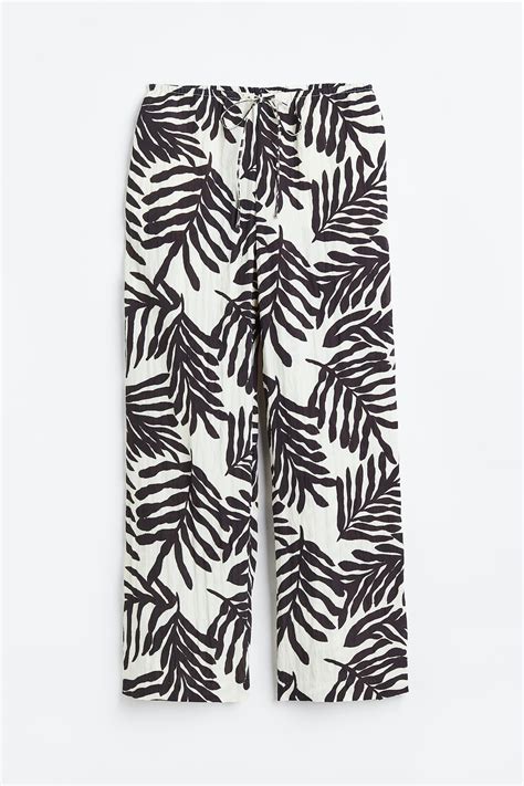 Wide pull-on trousers - White/Leaves - Ladies | H&M IN