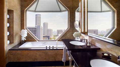 The Ritz-Carlton bath mat hung over standing bathtub