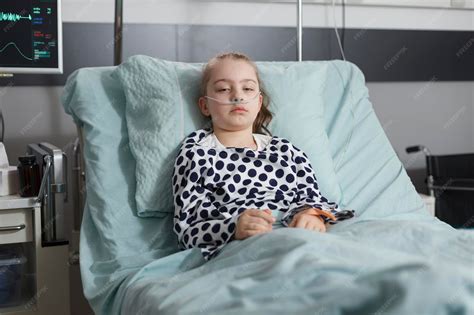 Premium Photo | Hospitalized sick little girl resting in children ...
