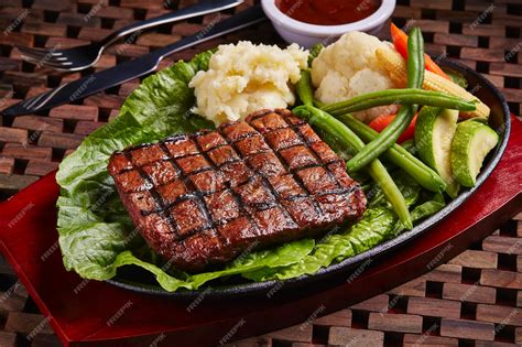 Premium Photo | Bbq beef steak with salad and sauce served in dish ...