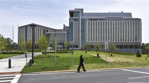 Modern educational building with landscaped grounds, featuring the ETTC sign, and a person walking in front, representing managed IT services in Pennsylvania.