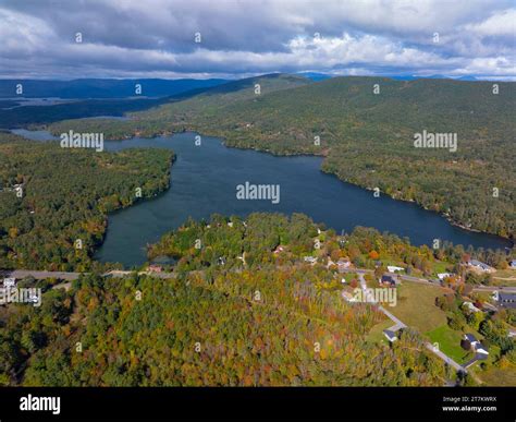 Lake Kanasatka near Lake Winnipesaukee with sunshine through clouds in ...