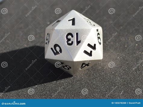 D20 Twenty-sided Golden Metallic Die Dice on Foam Background in Bright ...