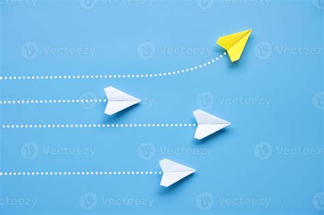 Top view of paper airplane - Yellow paper airplane origami flying to a ...
