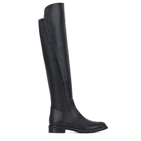 Black leather knee high top boots with a flat heels and fitted upper ...