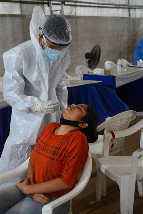 A medical staff wearing PPE dressed up as Maveli goes around ...
