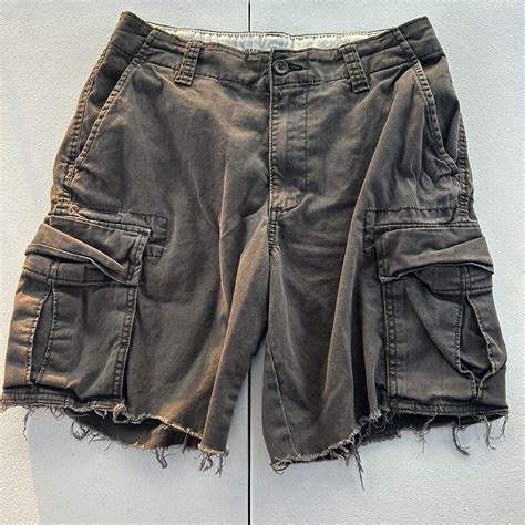 Vintage styled distressed faded cargo shorts, dark... - Depop