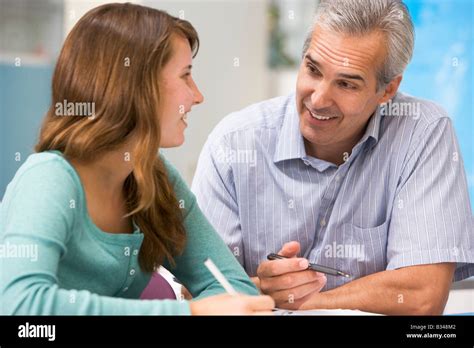 Teacher giving personal instruction to female student Stock Photo - Alamy
