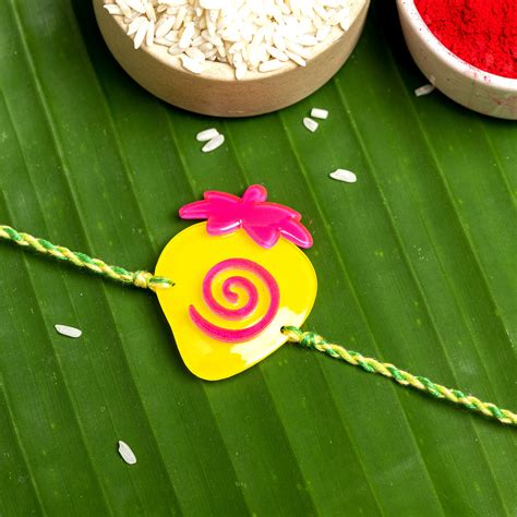Acrylic Yellow Pink Strawberry with Green Yellow Dori Rakhi and Roli ...