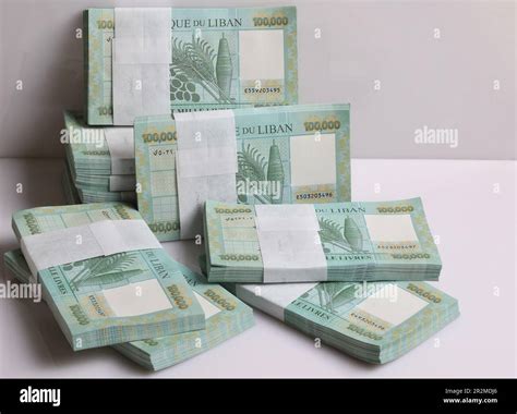 Stacks of Lebanese pounds, 100,000 denomination, symbolizing the downfall of the Lebanese ... - currency of lebanon